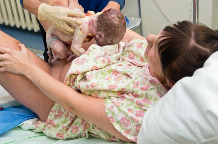 Young woman giving birth