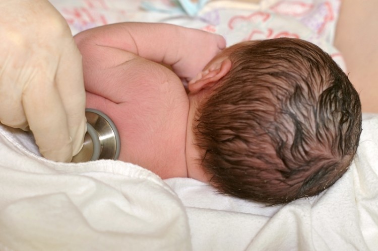 Closeup detail of newborn baby being examined with stethoscope ten minutes after birth_dreamstime_10112845
