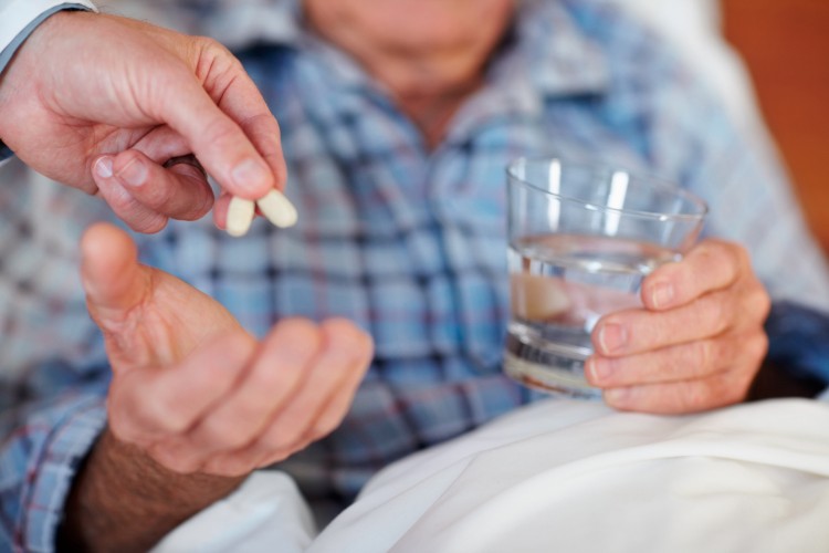 Closeup of an elderly man being given pills_dreamstime_11312558