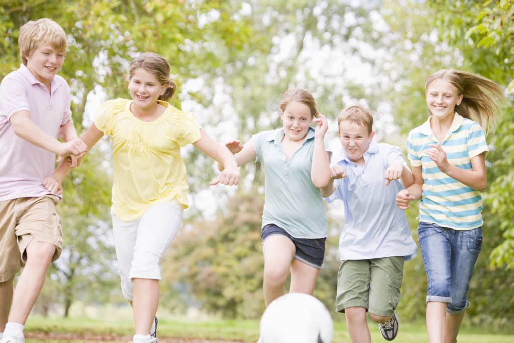 Five young friends playing soccer