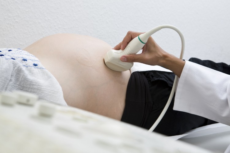 Pregnant woman getting ultrasound from doctor_dreamstime_12315090
