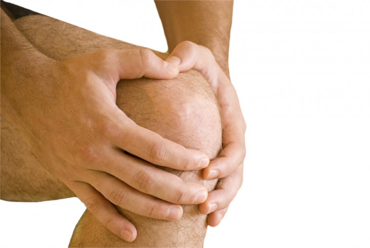 Man having pain in his knee making massage_dreamstime_15393922