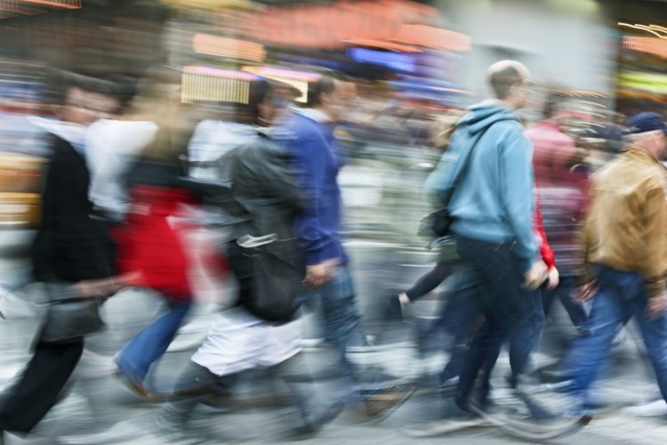 Abstract motion blur of a group of unrecognizable faces people crossing street_dreamstime_9244866
